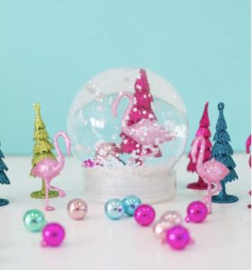 Snow globe with a pink flamingo and pink Christmas tree inside