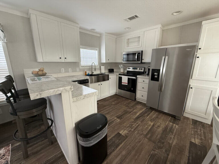Kitchen view with island and stainless steel appliances.