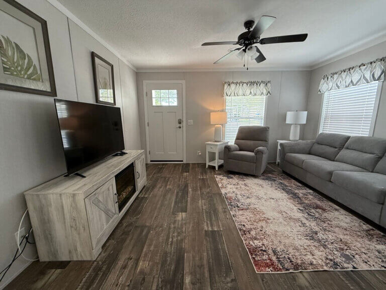 Inside view of living room with a couch, coffee table and tv at the adress:6602B Lakewood Dr