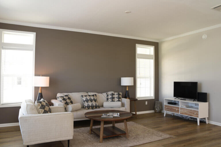 View of the living room featuring a couch, coffee table and TV.