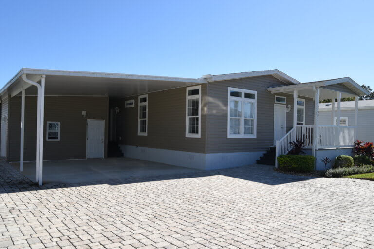 Outside view of brown manufactured home with the address of 6708C Lakewood Dr